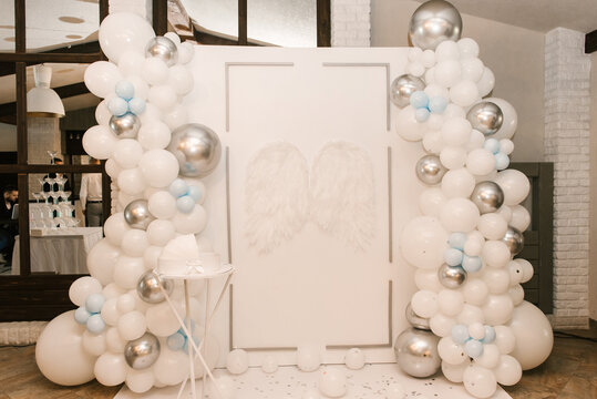 Beautiful white photo zone with balloons and angel wings