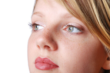 Fototapeta premium Face of beautiful young girl with green eyes and freckles