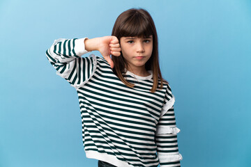 Fototapeta premium Little girl over isolated background showing thumb down with negative expression