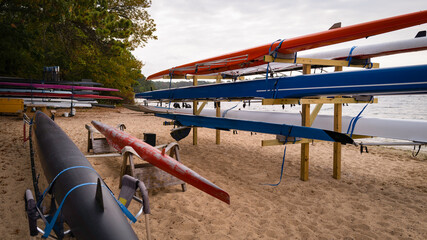 Recreational kayaks stacked on the racks on the beach