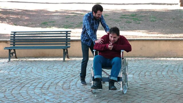 tactless friend - man jokes heavily with a man using wheelchair