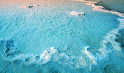 Fototapeta na wymiar Texture of the Dead Sea. Salty sea shore at sunrise