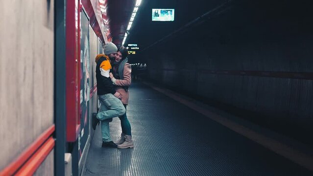 kill the time - young couple in love kisses at the metro station