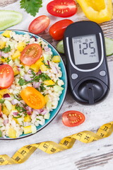 Glucometer for analyzing sugar level and salad with bulgur groats and vegetables. Diabetes,...