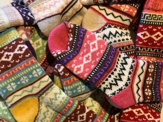 Blick von oben auf viele bunt gestrickte Wollsocken aus Skandinavien 