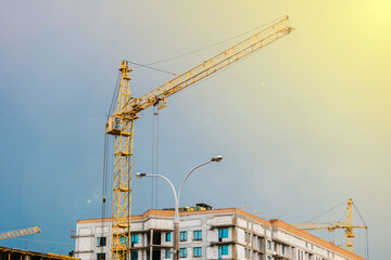 Construction of residential buildings, construction crane against the sky. Construction concept.