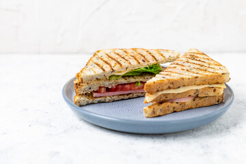 sandwich with ham cheese tomatoes lettuce onions on plate. Classic club sandwich with whole grain bread