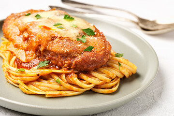 Plate of chicken parmigiana with spaghetti