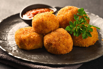 Plate of balls POTATO CROQUETTES and sauce close-up