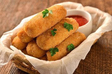 Basket of homemade potato croquettes and ketchup