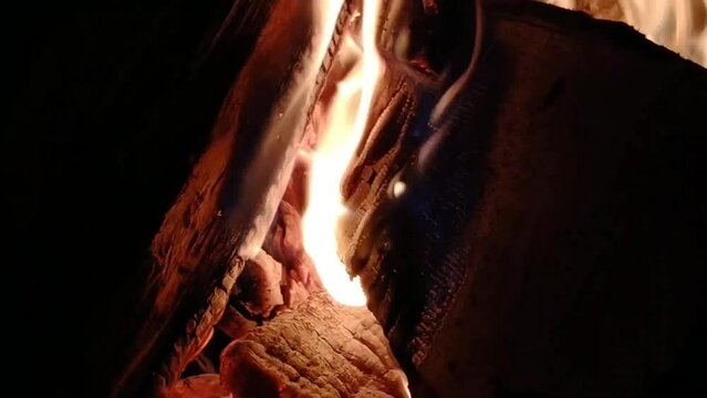 Relaxing video of a warm cozy burning fire in a brick fireplace.