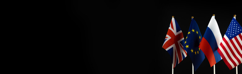 World crisis, war, banner. USA, EU, UK and Russian flag on black background. Conflict, sanctions...