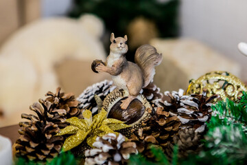 Christmas and New Year photo studio, green tree, figurine of a squirrel on nuts, white wall (2). Idea for holiday like Christmas and New year, for covers books, magazines, articles.
