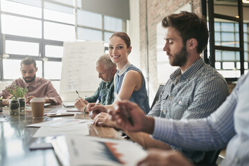 Success is one thing my teams knows well. Portrait of a businesswoman sitting in a meeting.