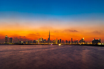 Stunning shot of Dubai City Skyline in the evening with a colorful sky.