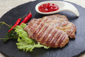 Grilled pork neck steak with ketchup