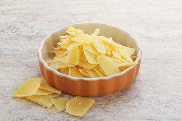 Sliced parmesan cheese heap in the bowl
