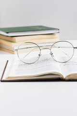 Eyeglasses on a book. Studying concept.