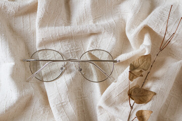 Eyeglasses on linen background. Autumn fashion concept.