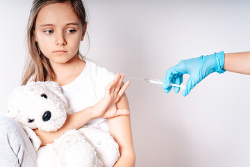 The child was given a vaccine.Female doctor or nurse trying to give shot or vaccine against virus...
