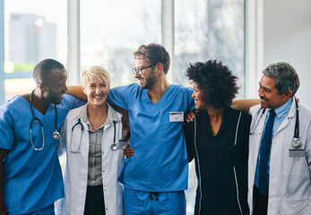 Together well take care of you. Portrait of a diverse team of doctors standing together in a...