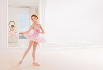 Fototapeta na wymiar Little girl ballerina dancer in tutu learning ballet dance at dance school