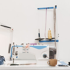 Modern sewing machine on designer work place in modern atelier