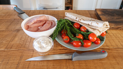 A set of raw products for homemade shawarma. Cooking traditional shawarma wrap with chicken and vegetables.