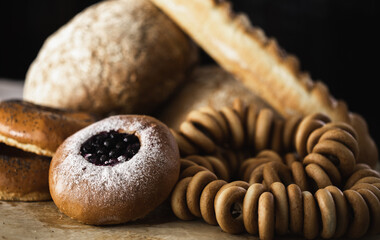 bakery products, bun with jam, bagels close-up on a dark background