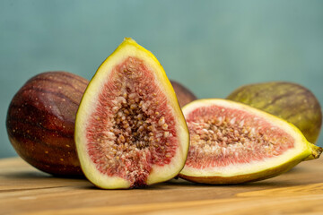 Fresh figs cut in half on wooden background, closeup