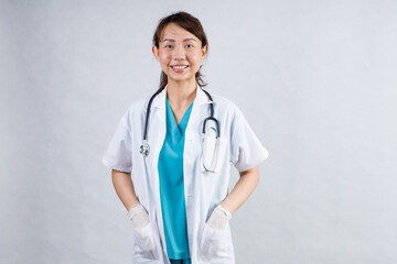 Happy beautiful female doctor in medical coat standing with crossed arms isolated on white.Asia look