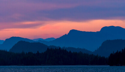 Twilight scene of ocean and mountains in Southeast Alaska, USA.