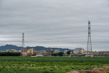 Fototapeta premium Cloudy days, power facilities in the fields, iron towers and telegraph poles