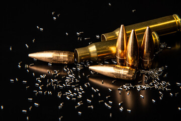 Close-up of disassembled rifle cartridges. Bullet isolated on black background with reflexion....