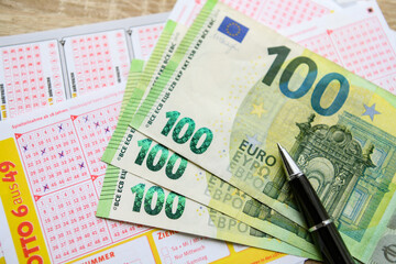 euro banknotes and lottery ticket, success concept