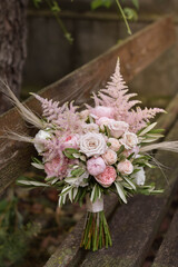 Wedding flowers, bridal bouquet closeup. Decoration made of roses, peonies and decorative plants, close-up, selective focus, nobody, objects. Wedding day.