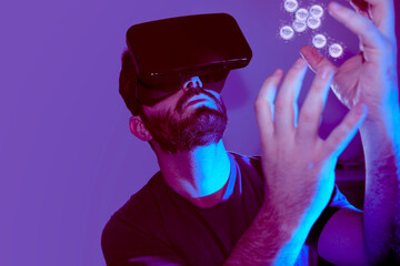 man with vr glasses receiving nft in the metaverse on lilac and dark background
