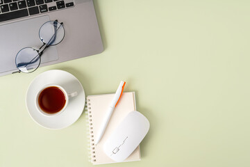 Simple Trendy Office Desk with laptop, tea mug and office elements. Home Office Desktop, top view