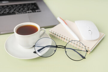 Simple Trendy Office Desk with laptop, tea mug and office elements. Home Office Desktop