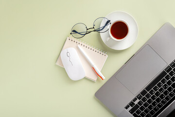 Simple Trendy Office Desk with laptop, tea mug and office elements. Home Office Desktop, top view