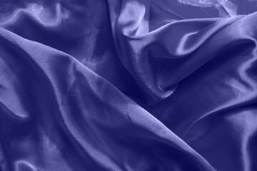 Beautiful violet silk background. Draped background of fabric, texture. Copy space. Close up