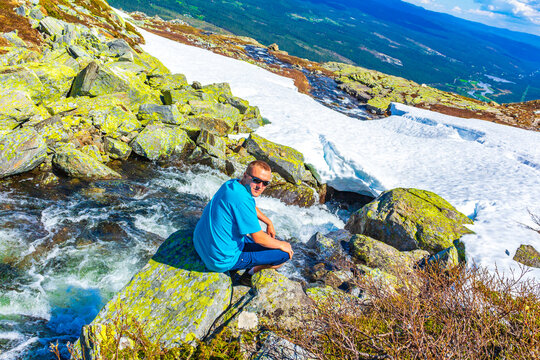 Tourist traveler at river of the Hydnefossen waterfall Hemsedal Norway.