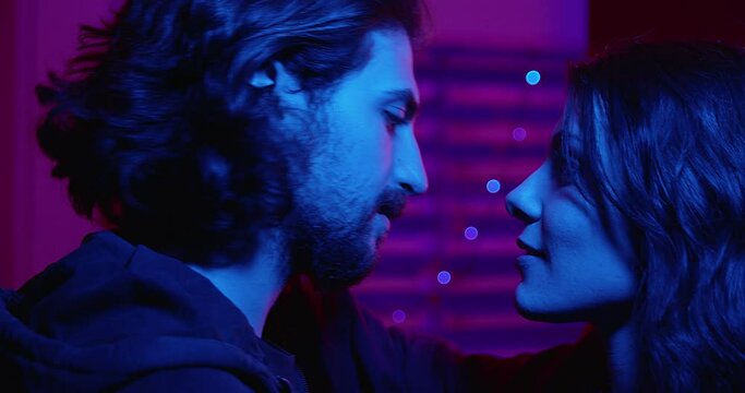 passion, attraction -couple looks into each other's eyes and kisses passionately