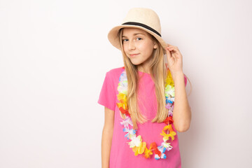 Beautiful relaxed little girl wearing straw hat standing isolated over white background. Holidays concept.
