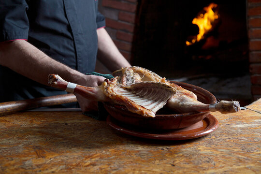 Anonymous chef with poultry in kitchen