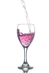 Filling red wine in glasses isolated on white background