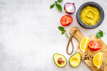 Homemade guacamole avocado dip with tomatoes and lime