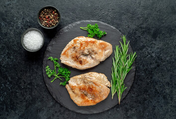 grilled chicken chops on stone background
