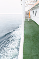 Fototapeta na wymiar Lateral view of a wake water splash from a ferry boat in the chilean patagonian channels.