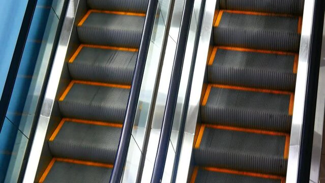 Close-up of two beautiful escalator tracks moving reversible